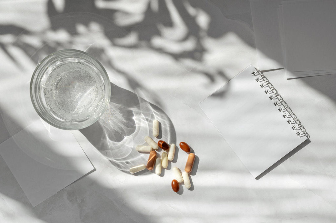 Marine collagen supplement capsules beside a glass of water in a simple daily wellness setting.
